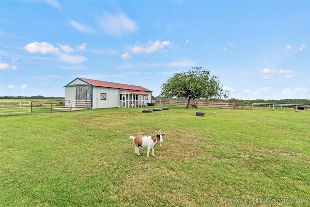 view of yard with a rural view and an outdoor structure