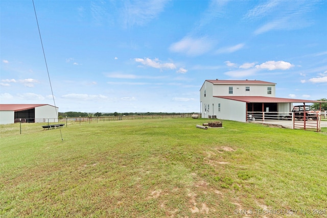 view of yard featuring a rural view and an outdoor structure