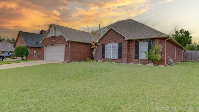 view of front of house with a garage and a yard