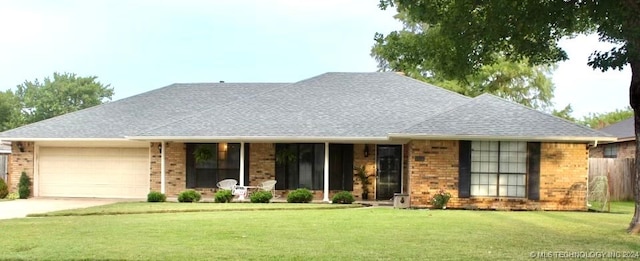 single story home with a garage and a front lawn