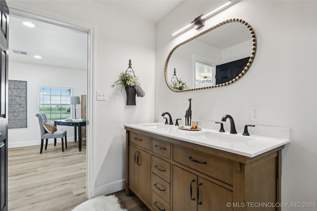 bathroom featuring double sink vanity and hardwood / wood-style floors