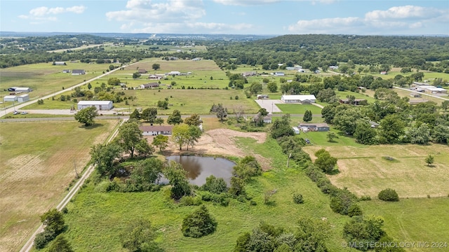 birds eye view of property with a water view and a rural view