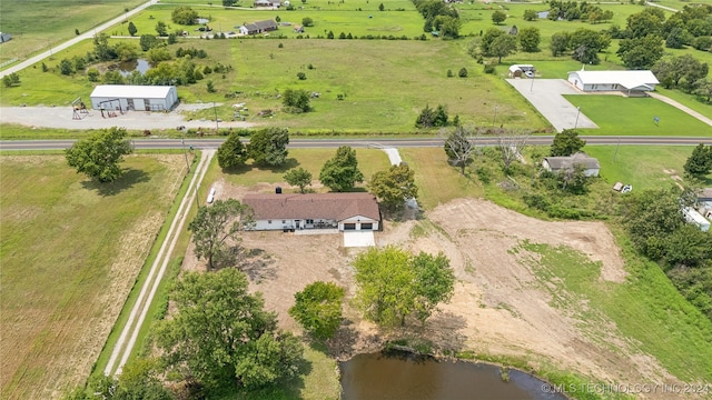 birds eye view of property featuring a water view and a rural view