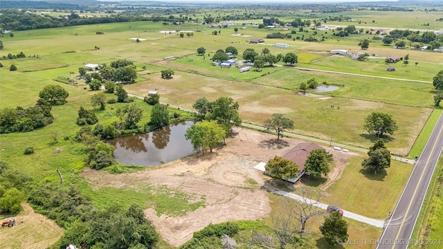 drone / aerial view featuring a rural view and a water view