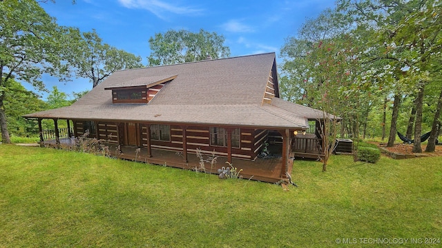 exterior space with cooling unit, a wooden deck, and a front lawn