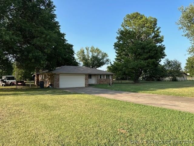 ranch-style house featuring an attached garage, concrete driveway, and a front yard