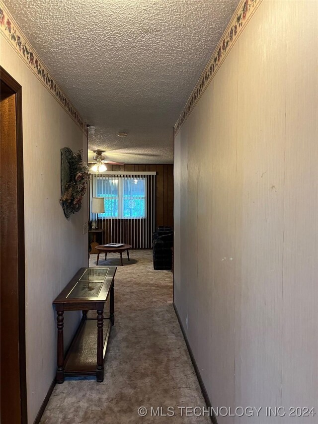 hallway with a textured ceiling