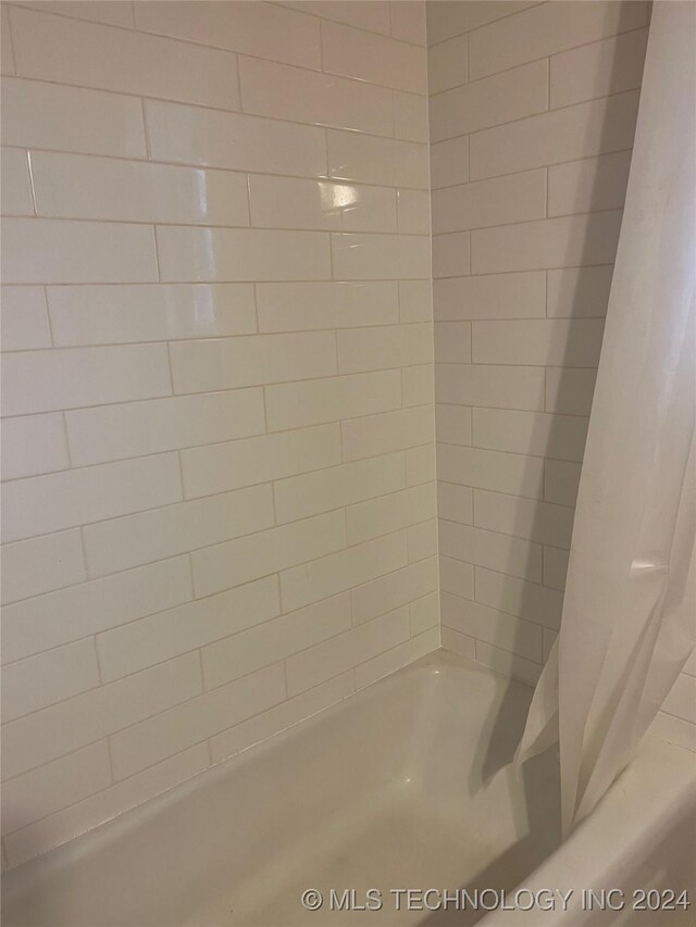 bathroom with shower / bath combination with curtain