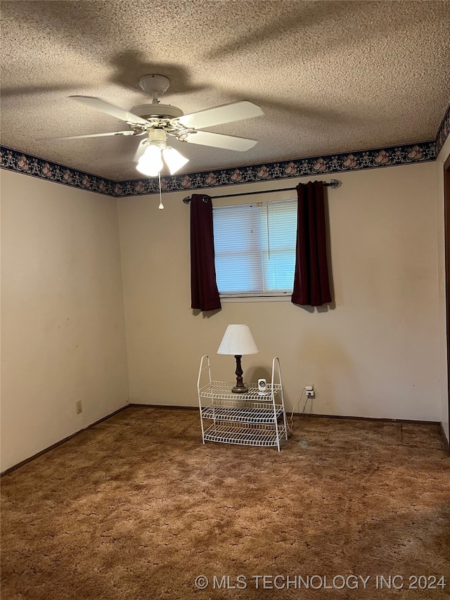 unfurnished room featuring a textured ceiling, ceiling fan, and carpet flooring