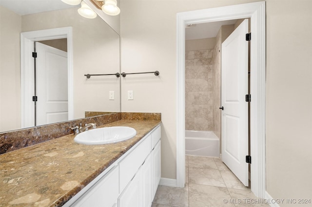 bathroom with vanity and tiled shower / bath combo