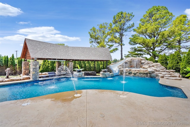 view of pool featuring pool water feature and a water slide