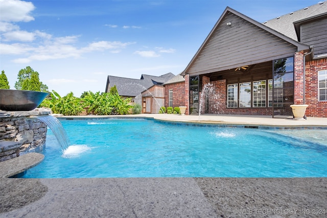 view of pool featuring pool water feature, ceiling fan, and a patio area