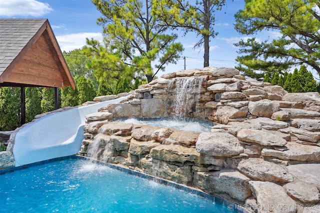 view of pool featuring pool water feature