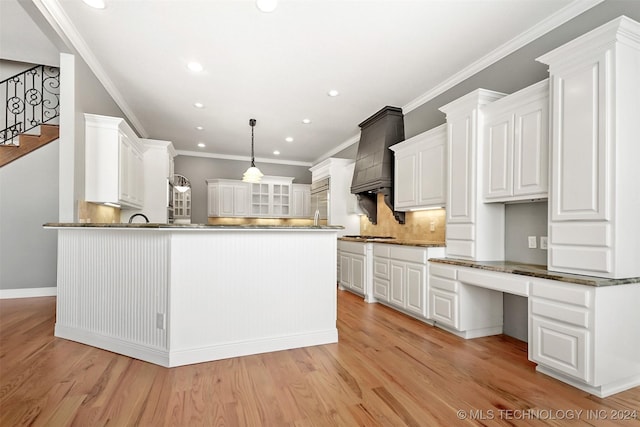 kitchen featuring white cabinetry, crown molding, and light hardwood / wood-style floors