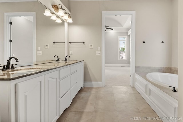 bathroom featuring tile patterned floors, vanity, a bathtub, and ceiling fan