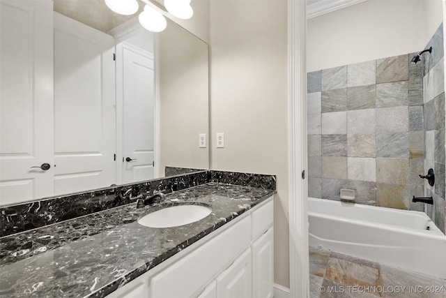 bathroom with tiled shower / bath combo, crown molding, and vanity