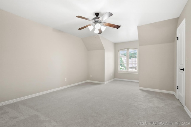 bonus room with light carpet, vaulted ceiling, and ceiling fan