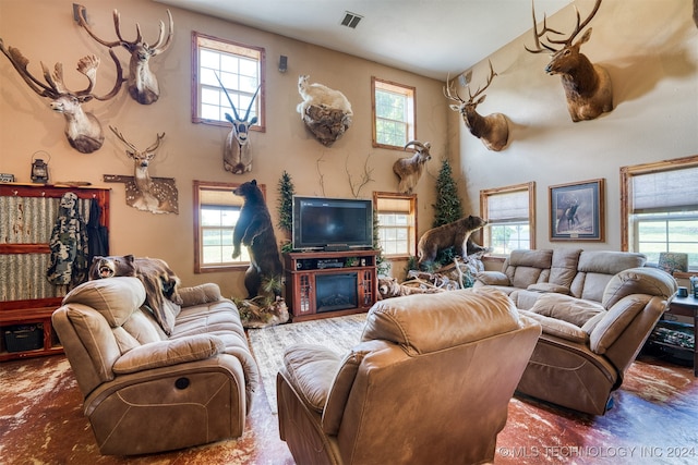 living room with a fireplace and a healthy amount of sunlight