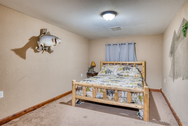 carpeted bedroom with a textured ceiling