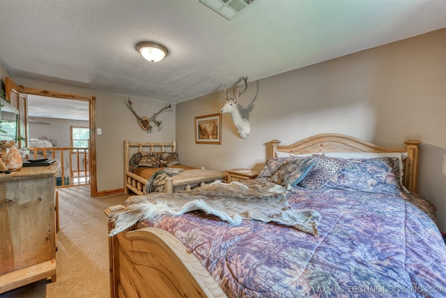 carpeted bedroom with a textured ceiling