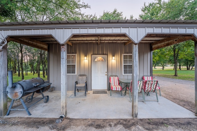 view of exterior entry with a patio