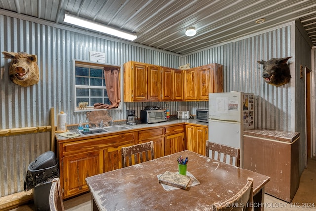 kitchen featuring a center island, sink, and white refrigerator