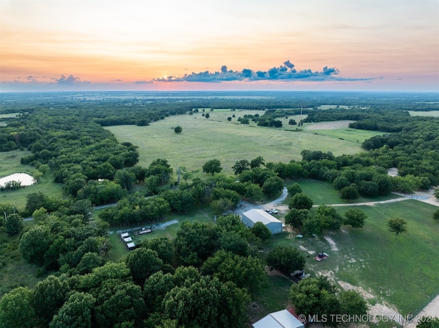 aerial view at dusk featuring a rural view