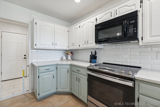 kitchen featuring tasteful backsplash, white cabinets, light tile patterned floors, and stainless steel electric stove