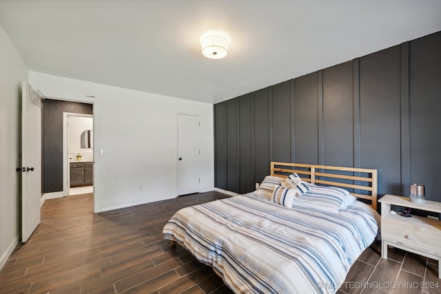 bedroom featuring hardwood / wood-style floors and ensuite bath