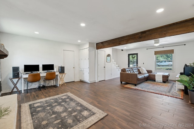 living room with dark wood-type flooring, beamed ceiling, and ceiling fan