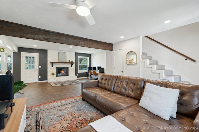 living room with a fireplace, a wealth of natural light, ceiling fan, and hardwood / wood-style floors