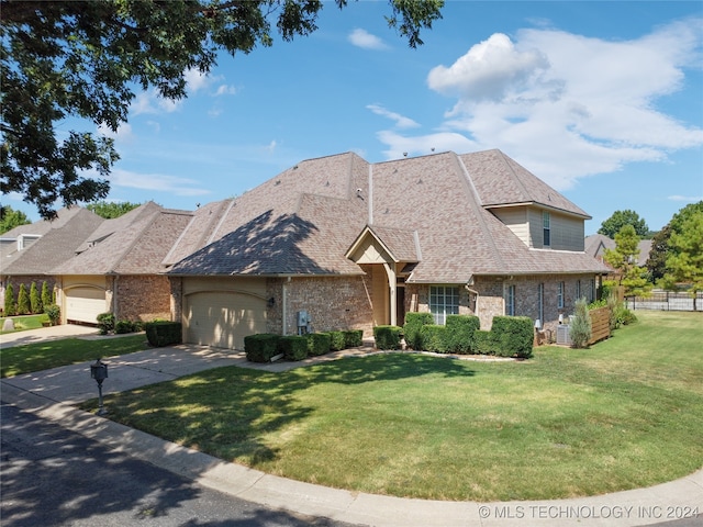 view of front facade with a garage and a front lawn