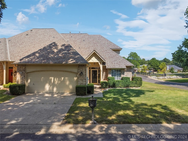 view of front of house with a garage and a front yard