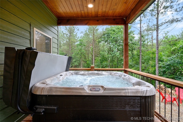 wooden terrace with a hot tub