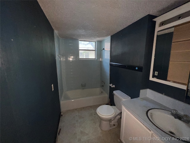 full bathroom with vanity, a textured ceiling, tiled shower / bath combo, and toilet