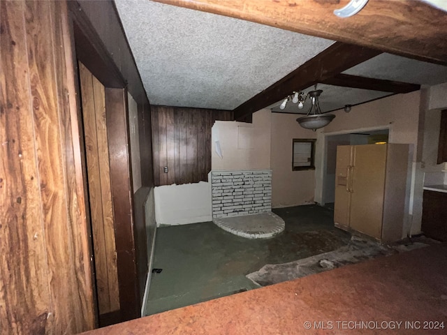 interior space with beamed ceiling and wood walls