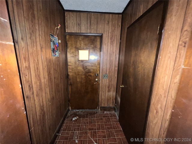 hallway with wood walls