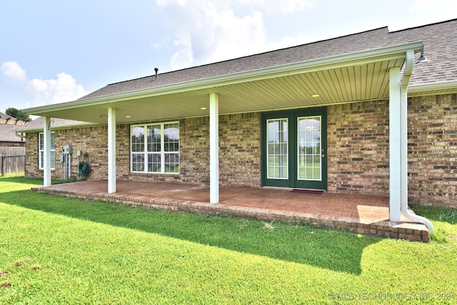 back of property featuring a yard and a patio area