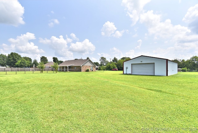 view of yard featuring a garage and an outdoor structure