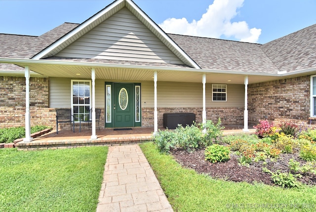 doorway to property with a porch and central AC