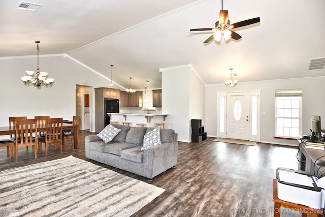 living room featuring lofted ceiling, ceiling fan with notable chandelier, dark wood-type flooring, and ornamental molding