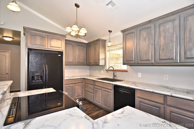 kitchen featuring vaulted ceiling, decorative light fixtures, sink, and black appliances