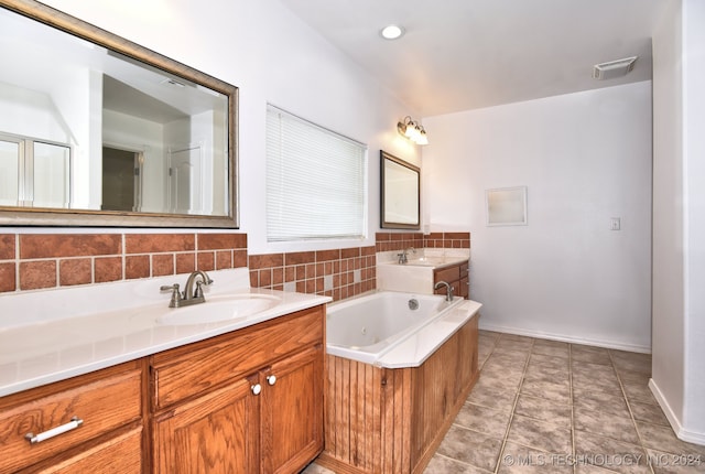 bathroom featuring tile patterned flooring, vanity, and tasteful backsplash