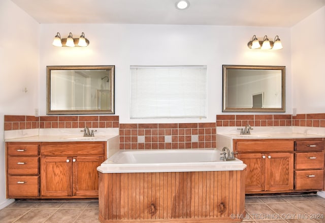 bathroom with vanity, tile patterned floors, and a tub to relax in