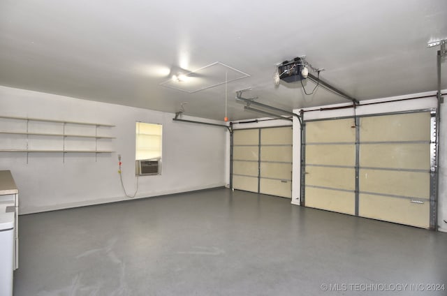 garage featuring cooling unit and a garage door opener