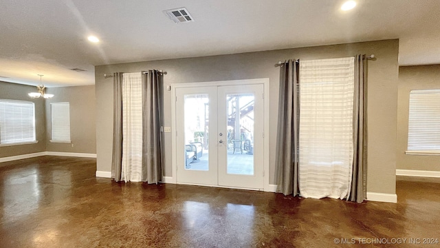 entryway featuring a chandelier and french doors