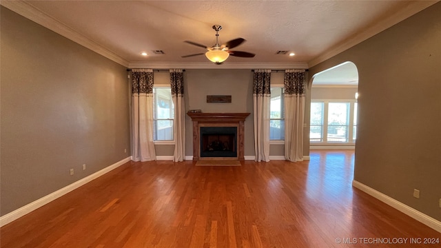 unfurnished living room with wood-type flooring, ceiling fan, and ornamental molding