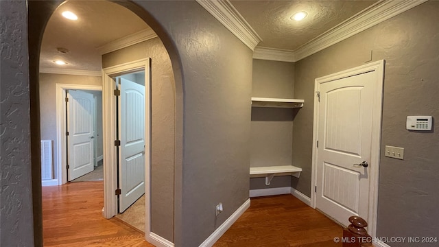 hall featuring crown molding and hardwood / wood-style floors