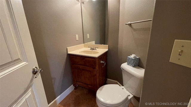 bathroom with tile patterned floors, vanity, and toilet