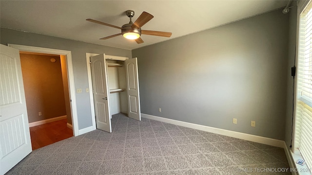 unfurnished bedroom featuring ceiling fan and light colored carpet